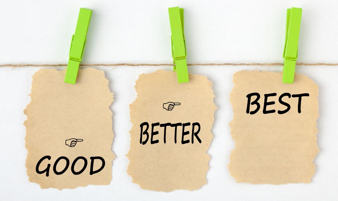 GOOD BETTER BEST writen on old torn paper with clip hanging on white background.
 Business concept words.