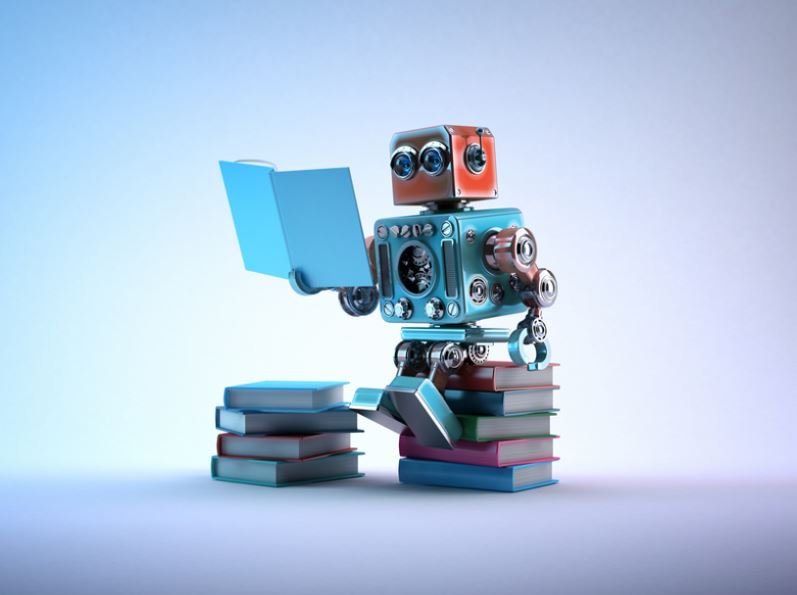 Robot sitting on a bunch of books.